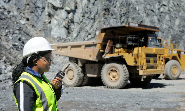 A miner is holding a portable radio1 PD780 E11