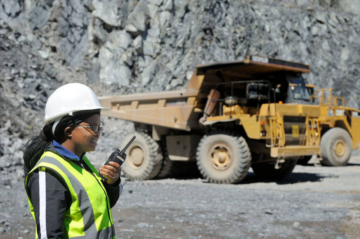 A miner is holding a portable radio1 PD780 E11